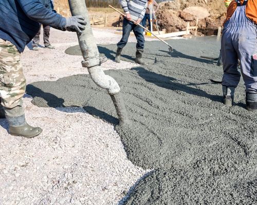 workers pouring concrete for a commercial parking lot